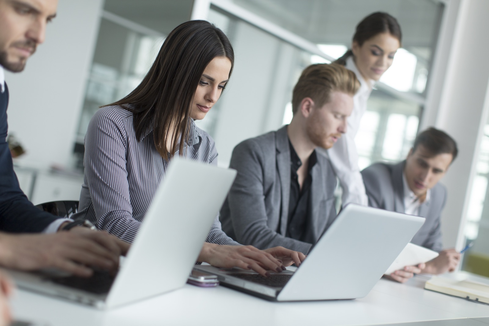 A team working together at laptops in a modern office